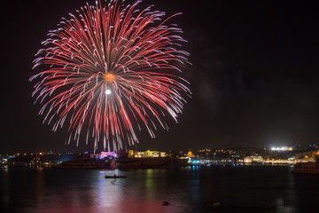 Orange , purple, red  and gold fireworks during a firework festival in Malta, 2018