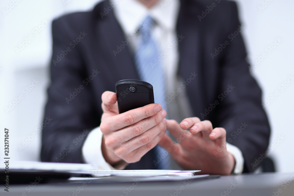 Wall mural close up.businessman typing text message on smartphone