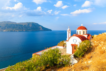 Fototapeta na wymiar White church on high cliff above sea near Karpathos port, Karpathos island, Greece