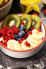 fruit bowl. Bowl of healthy fresh fruit salad on rustic background