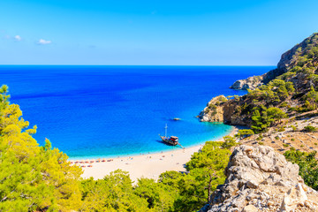 Tourist boat anchoring at beautiful Apella beach on Karpathos island, Greece