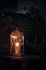lantern on a table next to a wall