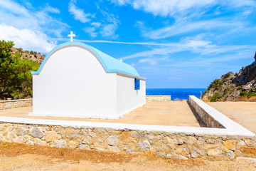White church along road to beautiful Achata beach, Karpathos island, Greece