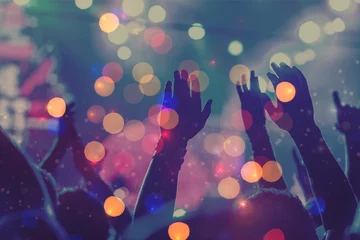  Audience with hands raised at a music festival and lights © BillionPhotos.com