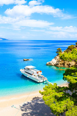Tourist boat anchoring at beautiful Apella beach on Karpathos island, Greece
