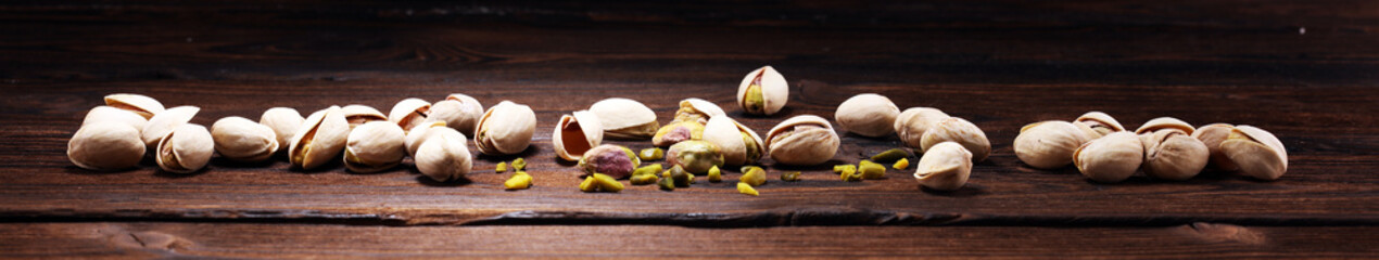 Pistachios, Roasted pistachio seeds in shells and shelled. Green, dried fruits, whole and chopped
