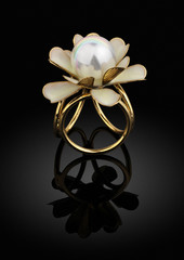 jewelry golden ring with pearl on black background with reflection © dimj