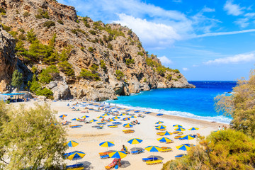 Beautiful Achata beach with colorful umbrellas and sunbeds, Karpathos island, Greece