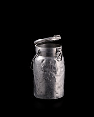 metal vintage milk can isolated on black background