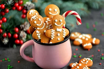 Tuinposter Christmas gingerbread cookie man in a mug decorated with icing © chudo2307