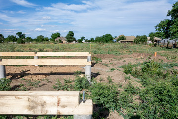 Fototapeta na wymiar Foundation construction. Unfinished frame house. Building process of the A-type frame house.