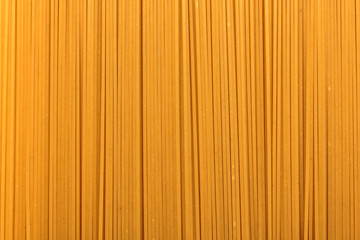Long spaghetti pasta closeup, raw state. Background, texture. Italian food.