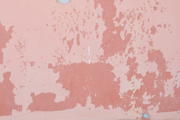 pink wall background with peeling paint