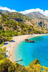 Sailing boat anchoring at beautiful Apella beach on Karpathos island, Greece - obrazy, fototapety, plakaty