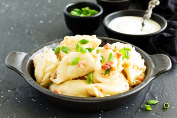 dumplings with potatoes in onion and bacon sauce. Varenyky, vareniki, pierogi, pyrohy.