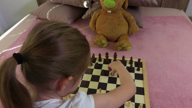 Girl is practicing in a chess game