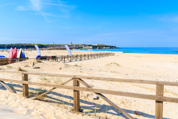 Wooden fence on sand dunes on beach in Tarifa town, Spain