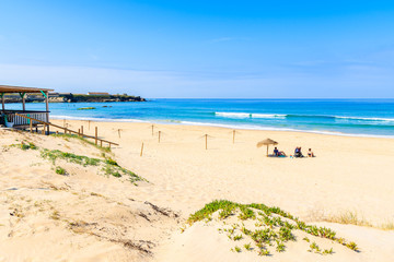 Unidentified people sunbathing on beach in Tarifa town, Spain
