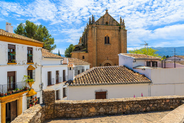 Church in Ronda village with white houses, Andalusia, Spain