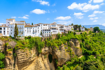 Fototapeta na wymiar White houses on green hills in Ronda village in spring, Andalusia, Spain