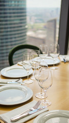 Wine glasses and plates on the table in restraint