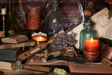 Antique Magic Book. Witchcraft Peacock feathers and candle background. Black candle Magic Ritual.