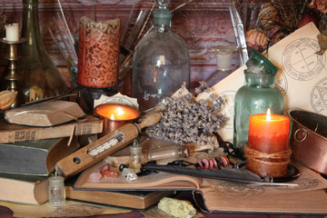 Antique Magic Book. Witchcraft Peacock feathers and candle background. Black candle Magic Ritual.