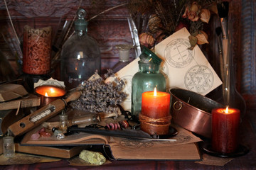 Antique Magic Book. Witchcraft Peacock feathers and candle background. Black candle Magic Ritual.