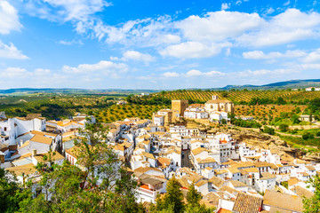 Fototapeta na wymiar White houses and church on hilltop in beautiful mountain village Setenil de las Bodegas, Andalusia, Spain