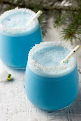 Blue curacao Christmas Cocktail on Christmas decorated holiday table © juliamikhaylova