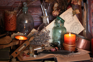 Antique Magic Book. Witchcraft Peacock feathers and candle background. Black candle Magic Ritual.