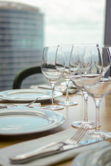 Wine glasses and plates on the table in restraint