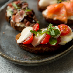 Caprese Bruschetta. Roasted bread with mozzarella, tomatoes and basil 