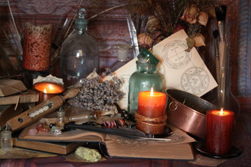 Antique Magic Book. Witchcraft Peacock feathers and candle background. Black candle Magic Ritual.