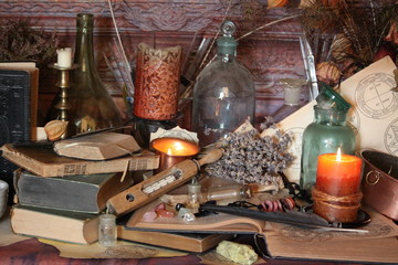 Antique Magic Book. Witchcraft Peacock feathers and candle background. Black candle Magic Ritual.