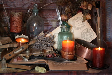 Antique Magic Book. Witchcraft Peacock feathers and candle background. Black candle Magic Ritual.