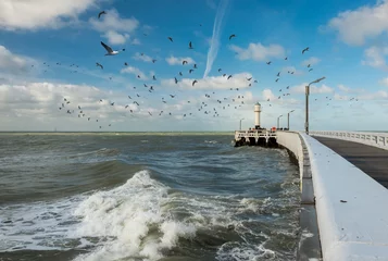 Gordijnen View on waves and old wooden pier of Nieuwpoort © Erik_AJV