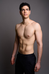 Fototapeta premium Young handsome man shirtless against gray background