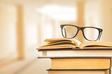 Books and glasses on  table  background,close up