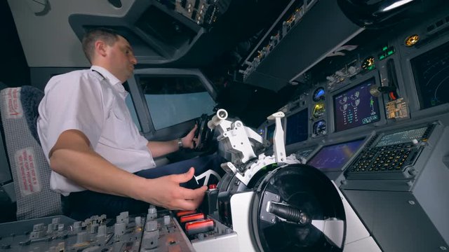 A person controls equipment in an airplane.
