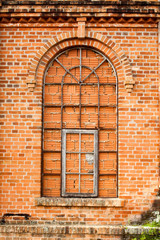 Closed windows in old orange brick wall