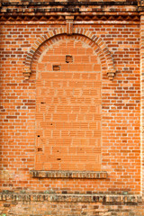 Closed windows in old orange brick wall