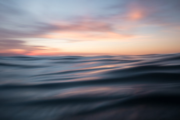 Fototapeta na wymiar Low angle view of sunset over ocean waves