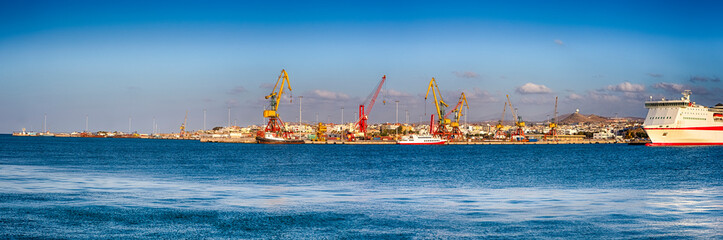 Fototapeta premium Panorama of Old Venetian Harbour, Port with Cranes and Lines of Cruise Ships in Heraklion City on Crete Island, Greece.