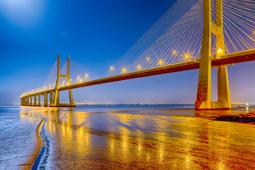 Famous and Renowned Picturesque Vasco Da Gama Bridge in Lisbon in Portugal. Picture Made At Night time.