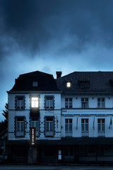 Fototapeta na wymiar Mansion with illuminated windows at dusk.
