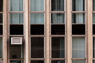 Modern glass windows in concrete building facade - urban modern architecture
