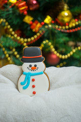 Cake snowman with a hat during Christmas time with Christmas Eve  on the background