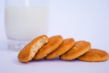 milk and biscuit on white background. side view.