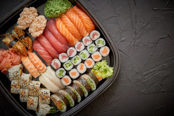 Japanese food concept. Catering, various kinds of sushi on plate or platter set. Chopsticks,...